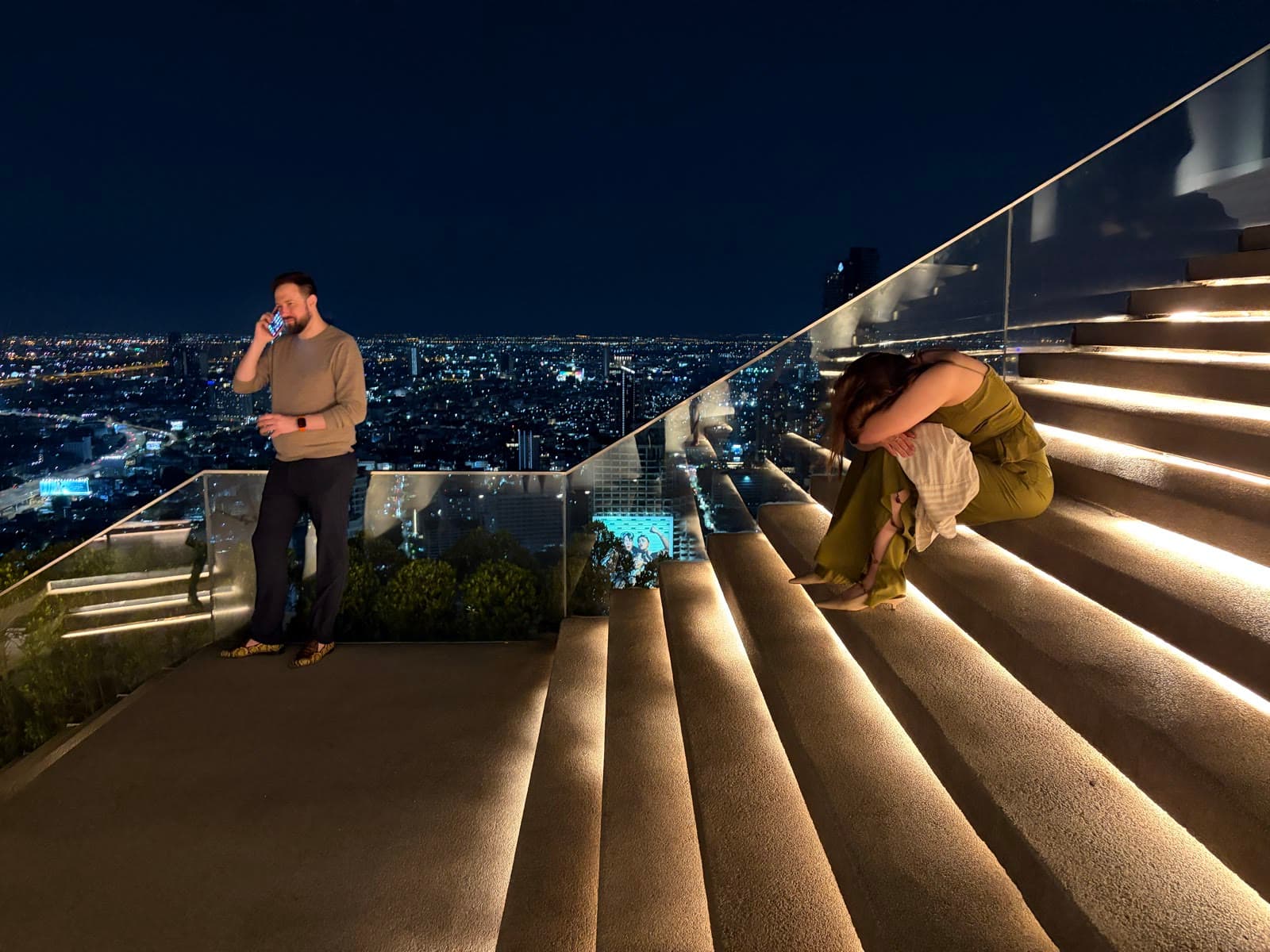 Oliver Locke of Sarasota, Florida taking a call on a rooftop high above Bangkok at night